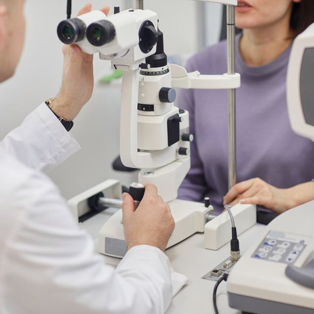 An optometrist performing a slit-lamp eye examination